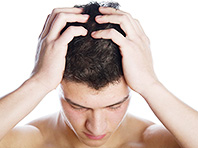 Dark-haired man holding his head in his hands - ibxaka01075130.jpg